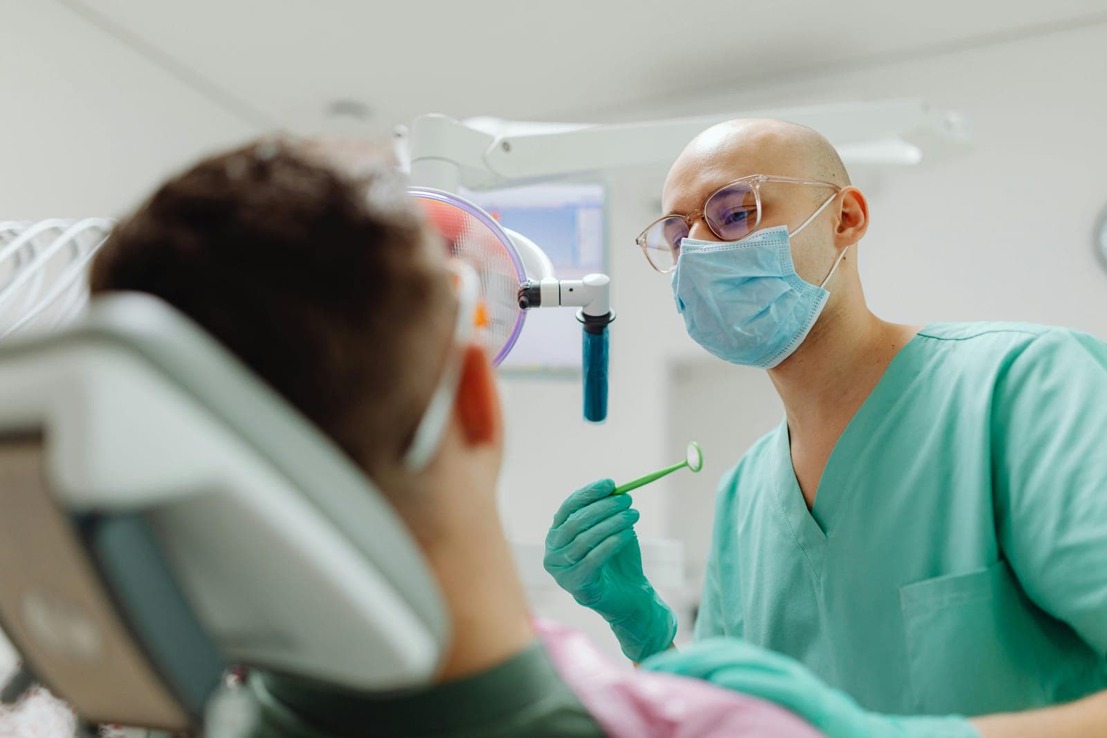 A patient and dentist sharing a confident smile after care